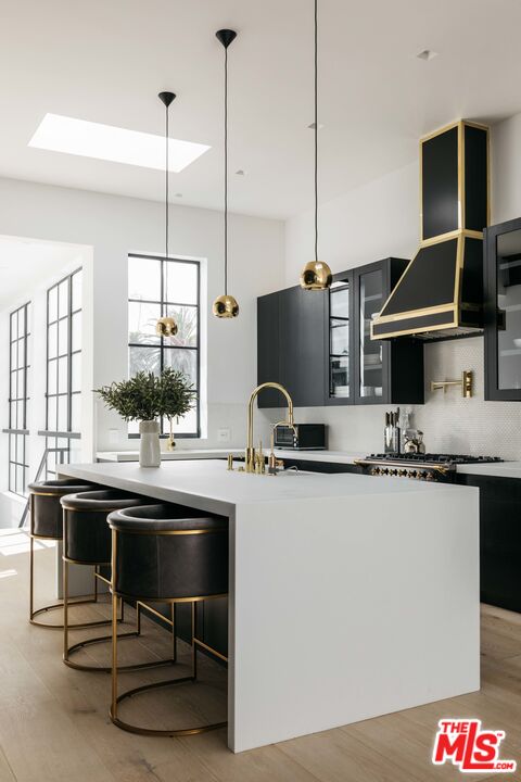 1346 Abbot Kinney Boulevard Venice, CA 90291 - Photo 10 of 18 a kitchen with stainless steel appliances granite countertop a sink a stove and a wooden floors