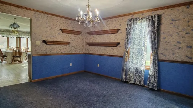 a view of a livingroom with furniture and chandelier kitchen