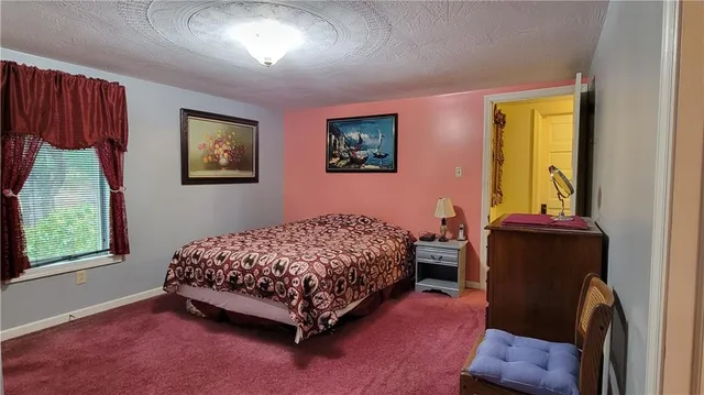a bedroom with bed and cabinets