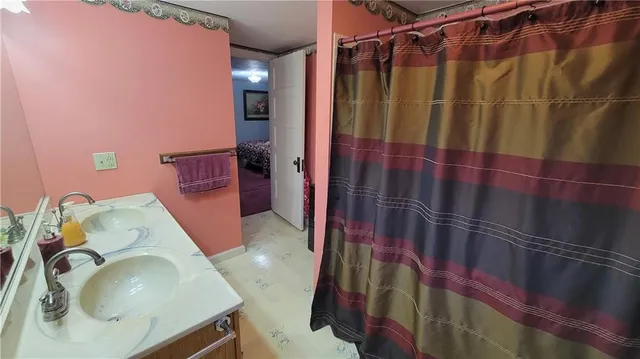 a bathroom with a double vanity sink mirror and toilet