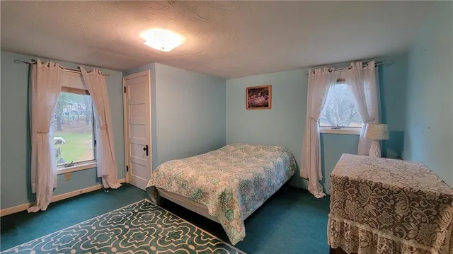 a bedroom with bed and a window