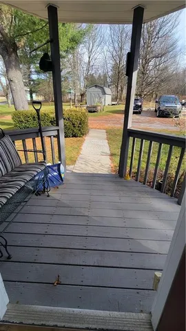 a view of a balcony with floor to ceiling windows wooden floor