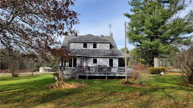 a view of a house with backyard and sitting area