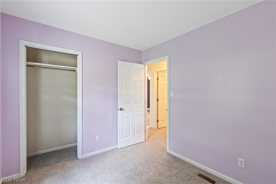 54131 Key Bellaire Road Bellaire, OH 43906 - Photo 23 of 36 Unfurnished bedroom with light carpet and a closet