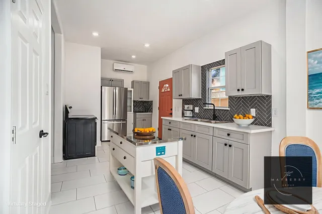 a kitchen with stainless steel appliances granite countertop a refrigerator and a stove top oven