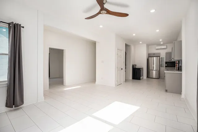 a view of a kitchen with a refrigerator and a sink