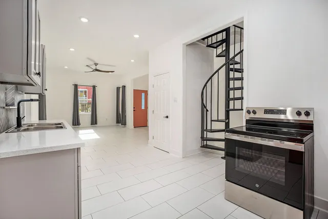 a kitchen with stainless steel appliances granite countertop a sink stove and refrigerator