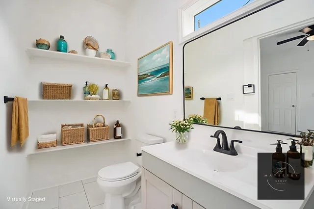 a bathroom with a sink a toilet and a mirror