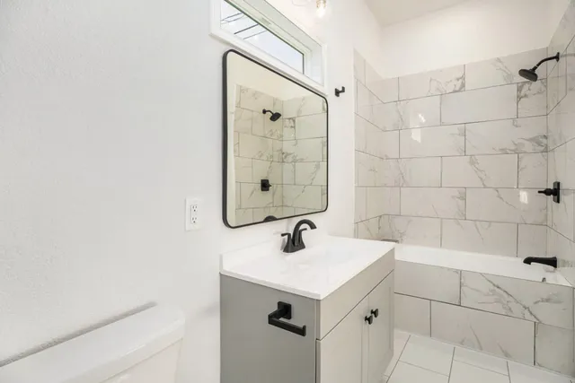 a bedroom with a bed and a potted plant