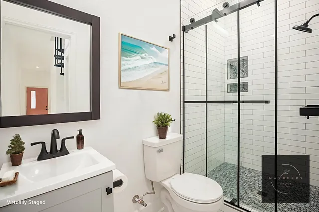 a bathroom with a toilet sink and mirror