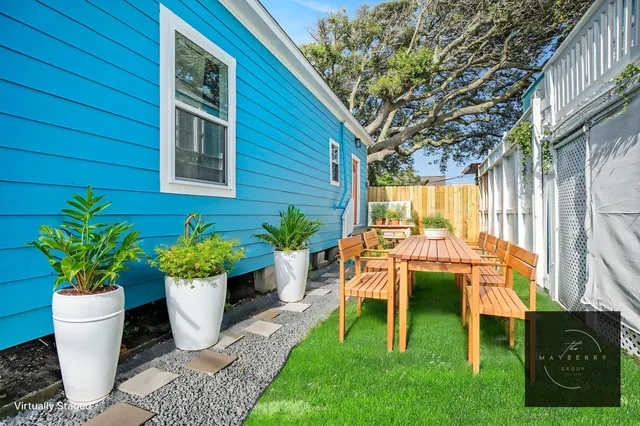 an aerial view of multiple houses with a yard