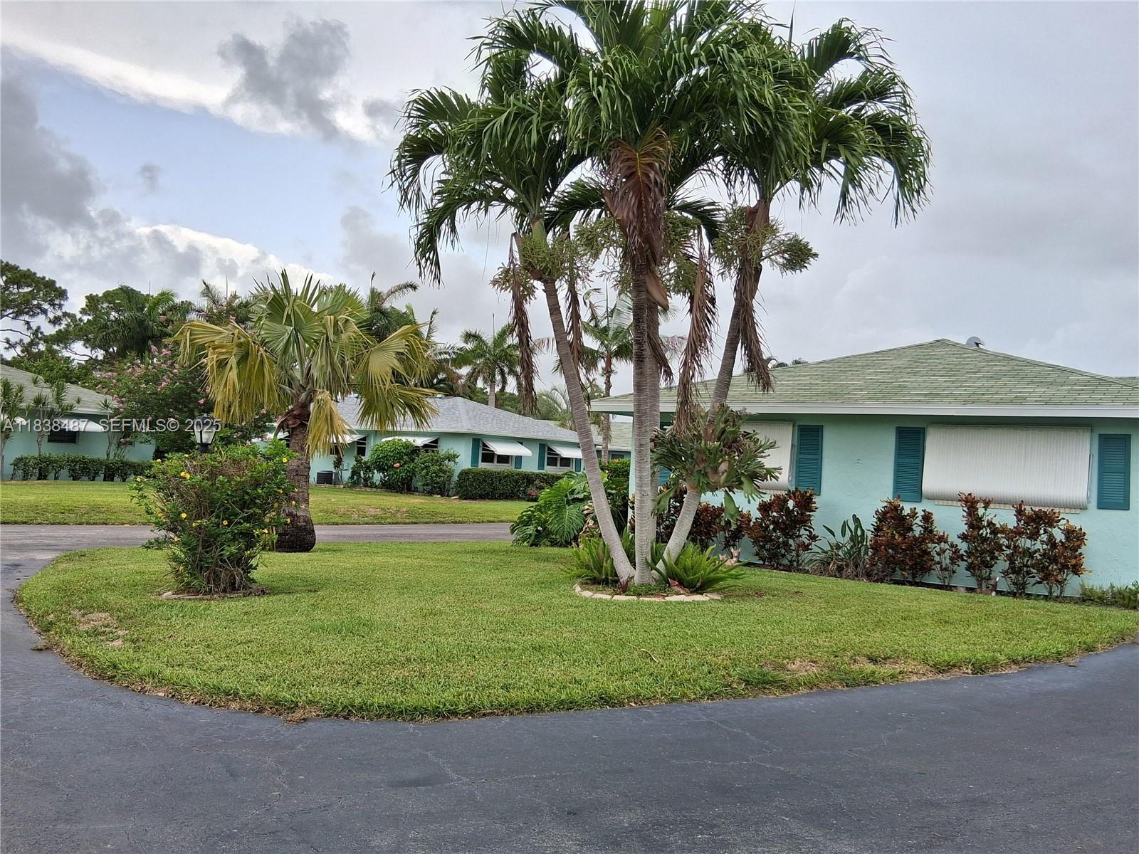 635 Hummingbird Lane Delray Beach, FL 33445 - Photo 1 of 21 a front view of house with yard and green space