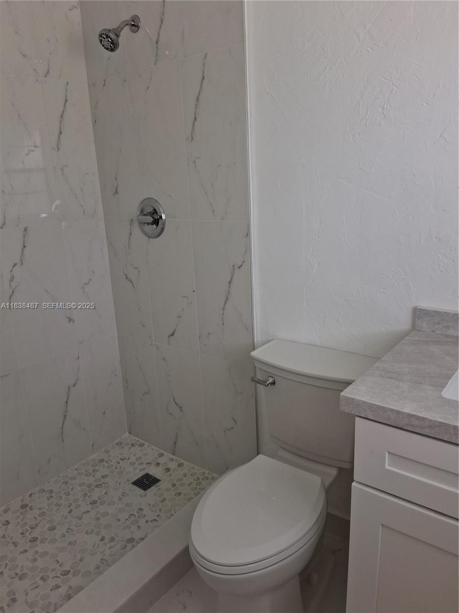 635 Hummingbird Lane Delray Beach, FL 33445 - Photo 14 of 21 a white toilet sitting next to a shower