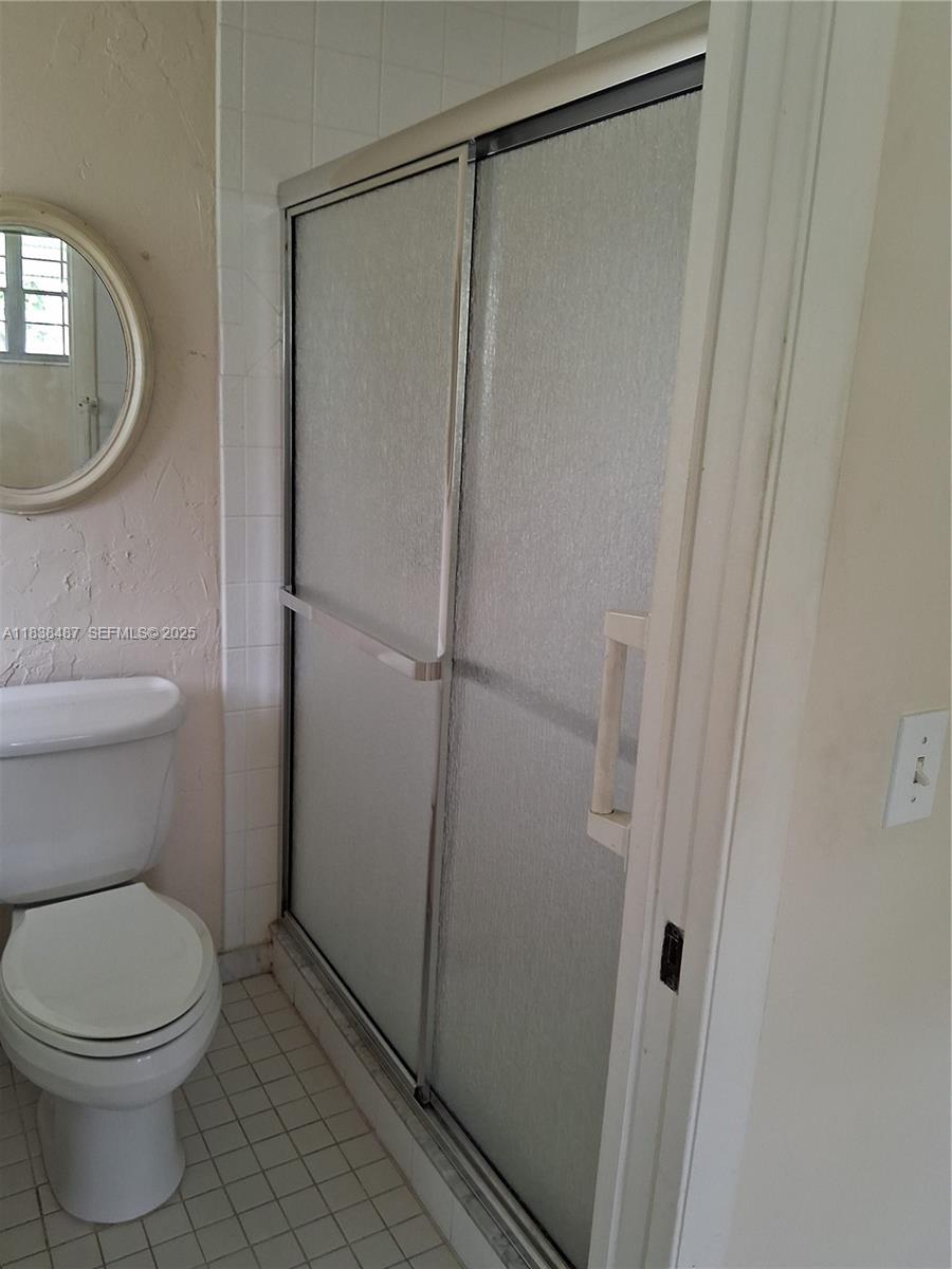 635 Hummingbird Lane Delray Beach, FL 33445 - Photo 17 of 21 a bathroom with a toilet and a shower