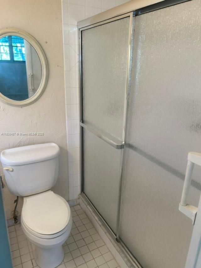 635 Hummingbird Lane Delray Beach, FL 33445 - Photo 18 of 21 a white toilet sitting next to a shower