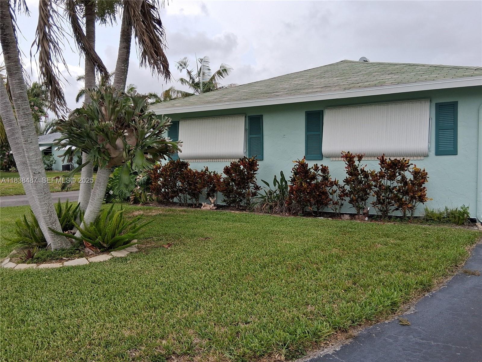 635 Hummingbird Lane Delray Beach, FL 33445 - Photo 2 of 21 a view of a house with a garden