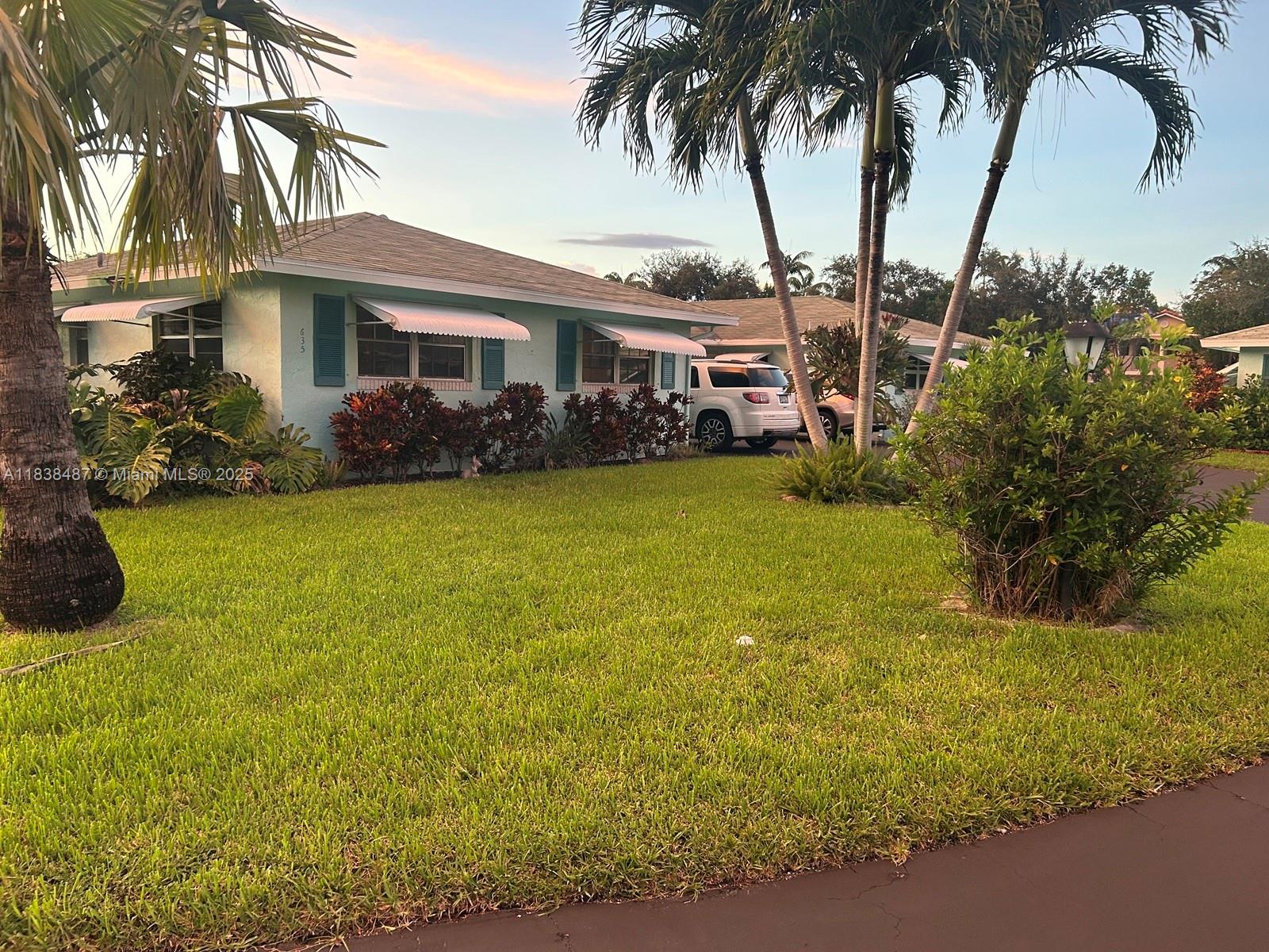 635 Hummingbird Lane Delray Beach, FL 33445 - Photo 3 of 21 a front view of a house with garden