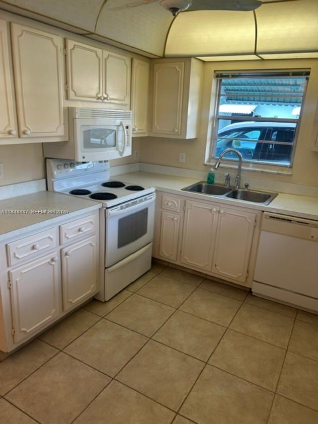 635 Hummingbird Lane Delray Beach, FL 33445 - Photo 4 of 21 a kitchen with stainless steel appliances granite countertop a sink and cabinets