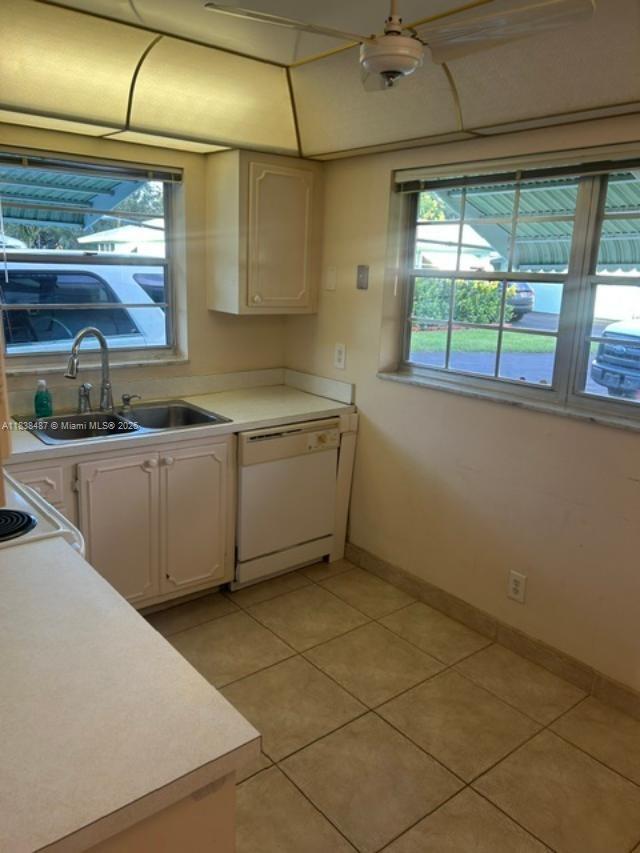 635 Hummingbird Lane Delray Beach, FL 33445 - Photo 5 of 21 a kitchen with stainless steel appliances a sink window and cabinets