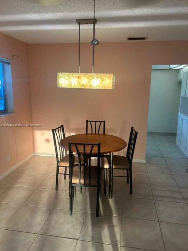 635 Hummingbird Lane Delray Beach, FL 33445 - Photo 8 of 21 a view of a dining room with furniture and chandelier