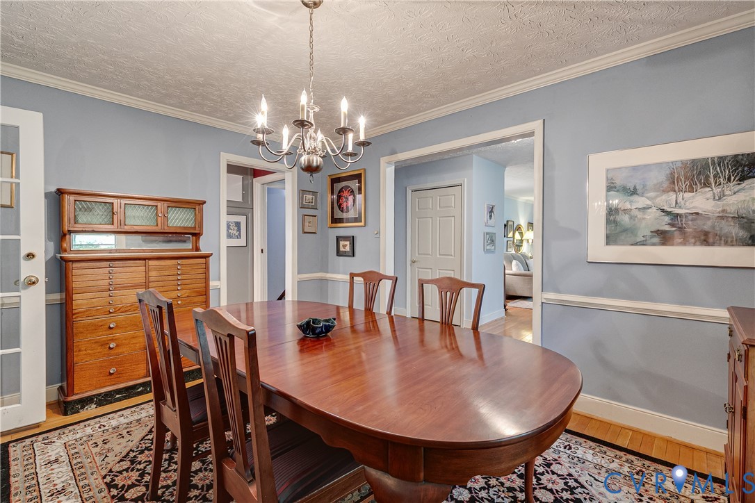 4411 Arrowhead Road Richmond, VA 23235 - Photo 13 of 33 a view of a dining room with furniture window and wooden floor