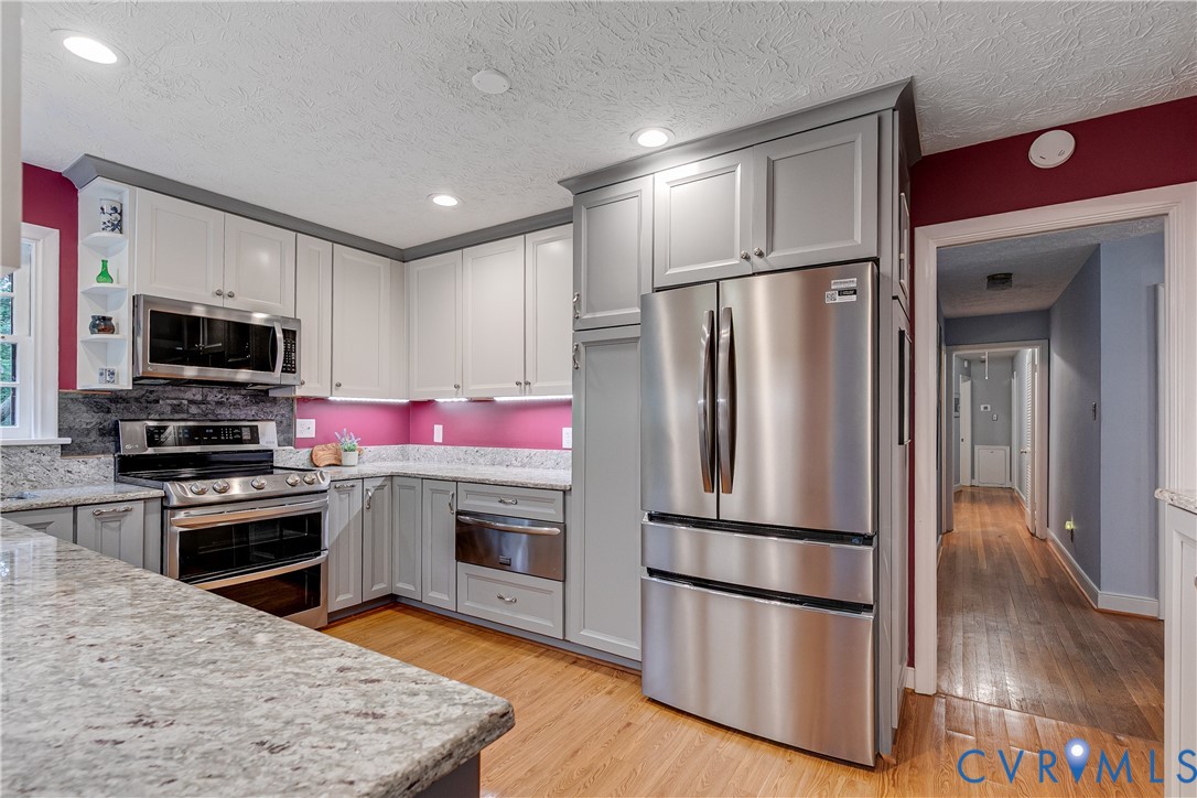 4411 Arrowhead Road Richmond, VA 23235 - Photo 16 of 33 a kitchen with stainless steel appliances granite countertop a refrigerator stove and microwave