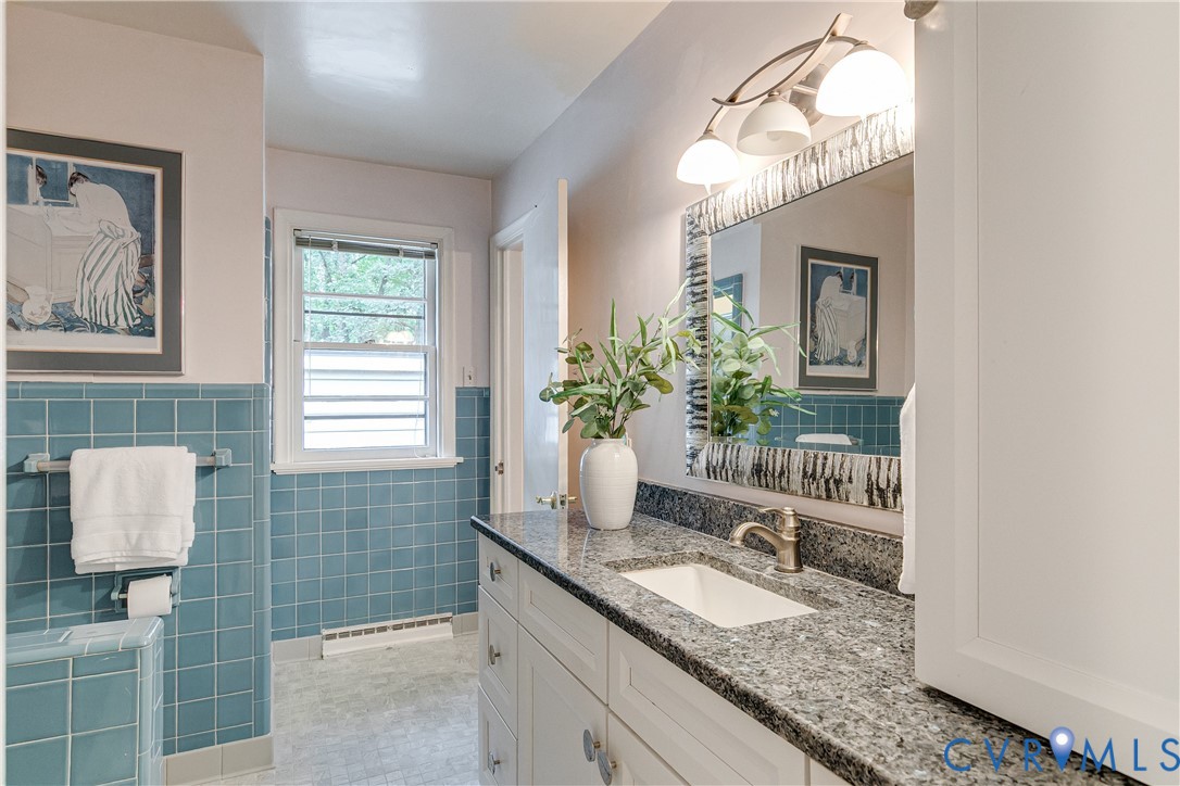 4411 Arrowhead Road Richmond, VA 23235 - Photo 24 of 33 a bathroom with a granite countertop sink a toilet and mirror