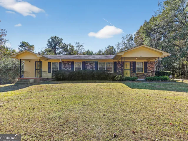 a view of a house with swimming pool and a chairs