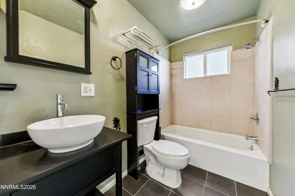 a bathroom with a sink a toilet and bathtub
