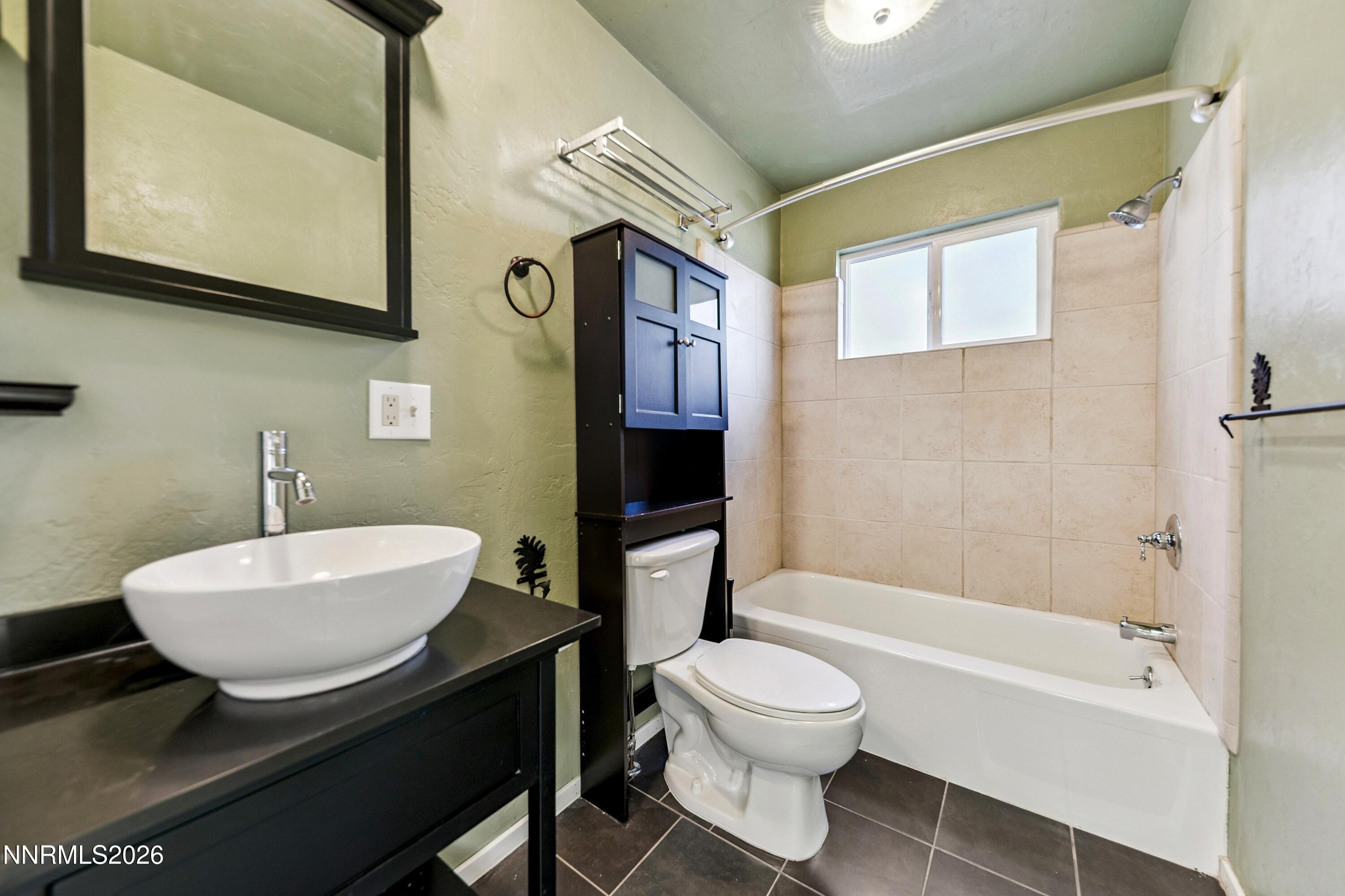 219 South Benjamin Drive, Unit B Stateline, NV 89449 - Photo 13 of 22 a bathroom with a sink a toilet and bathtub