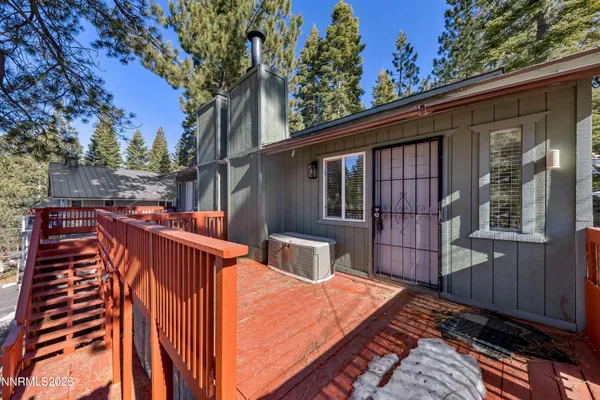 a backyard of a house with wooden floor and fence