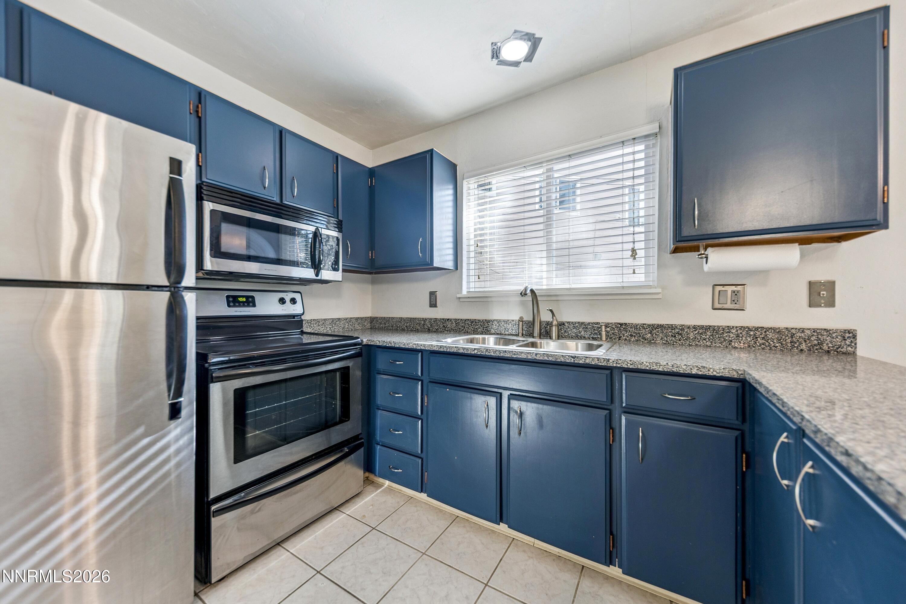 219 South Benjamin Drive, Unit B Stateline, NV 89449 - Photo 2 of 22 a kitchen with granite countertop a refrigerator stove and sink