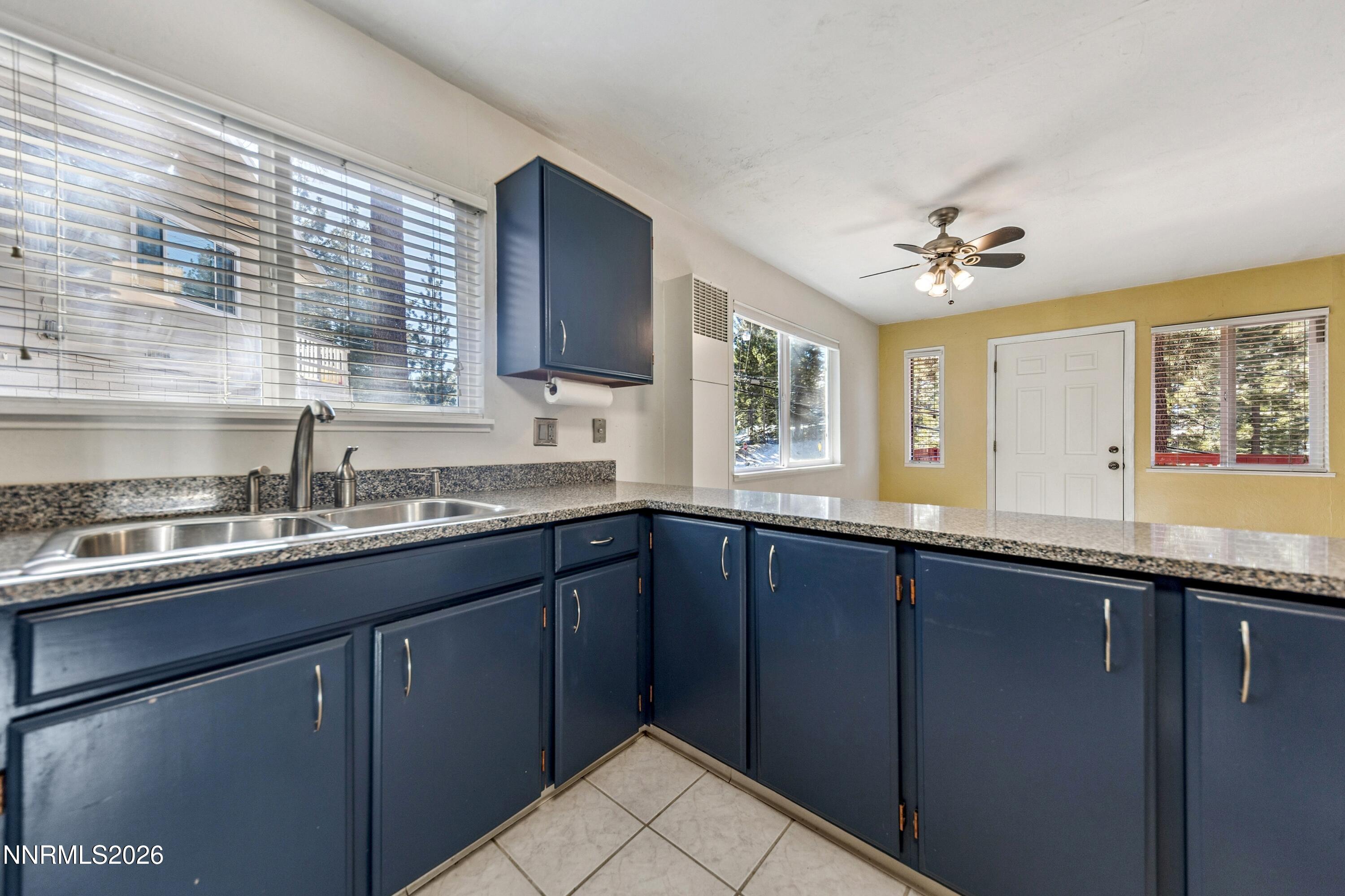 219 South Benjamin Drive, Unit B Stateline, NV 89449 - Photo 3 of 22 a kitchen with granite countertop a sink stainless steel appliances and cabinets