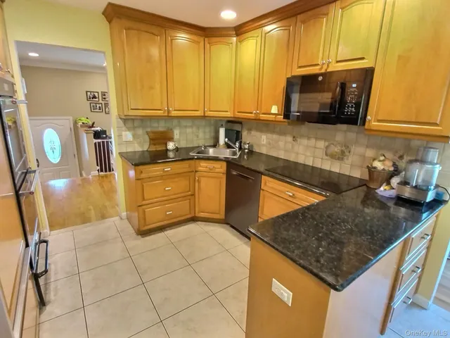 a kitchen with stainless steel appliances granite countertop a sink stove and cabinets