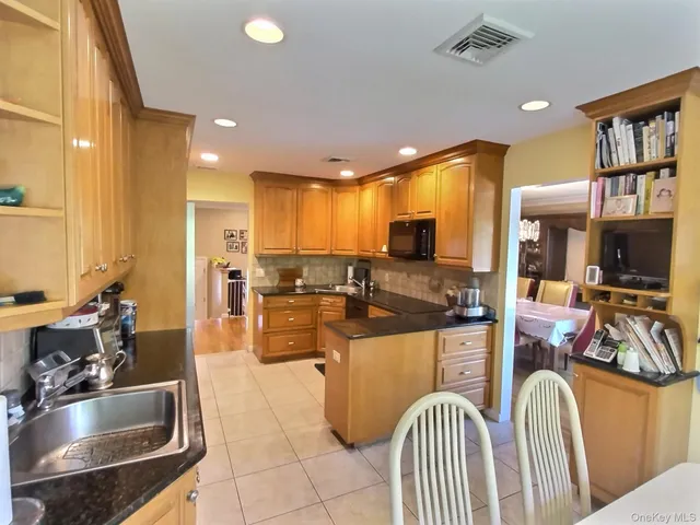a kitchen with counter top space a sink and a refrigerator