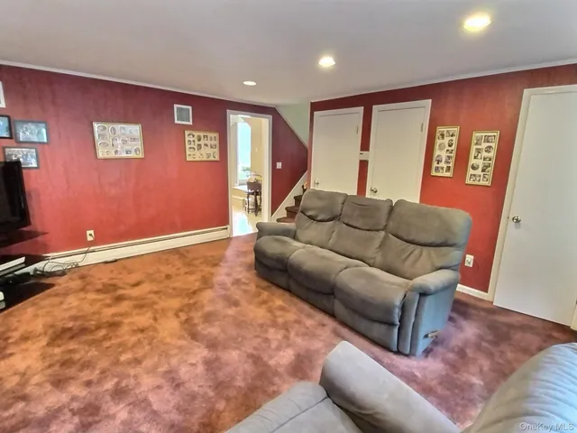 a living room with furniture and a rug