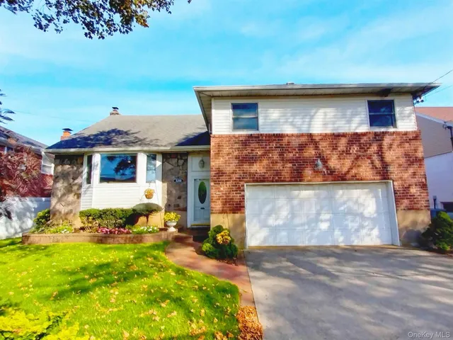 a front view of a house with a garden and yard