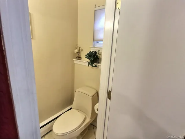 a white toilet sitting next to a shower