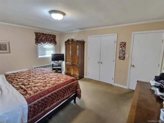 a bedroom with a bed and a dresser in it