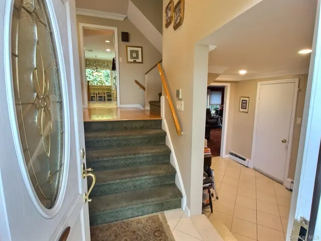 a view of a hallway with wooden floor and entryway
