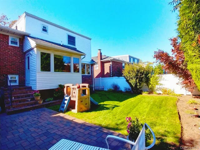 a view of a backyard with swimming pool