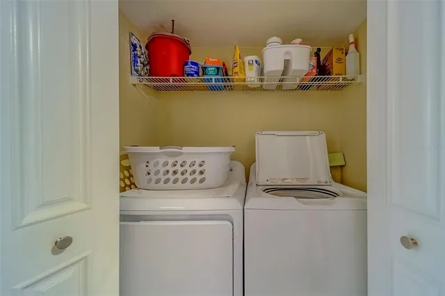 a view of a dining room and livingroom with furniture wooden floor a chandelier