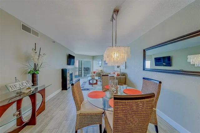 a dining room with furniture potted plants and wooden floor