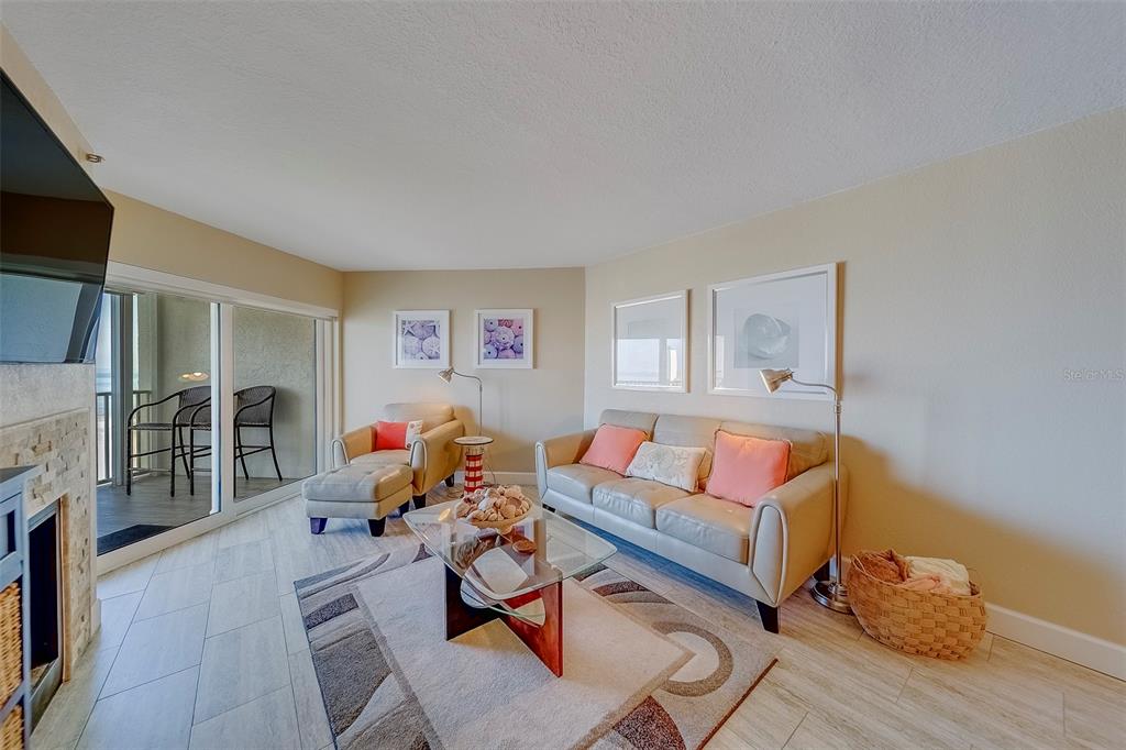 17980 Gulf Boulevard, Unit 402 Redington Shores, FL 33708 - Photo 18 of 63 a living room with furniture fireplace and a flat screen tv