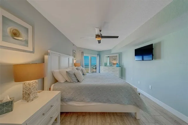 a spacious bathroom with a granite countertop sink a toilet a shower and a mirror