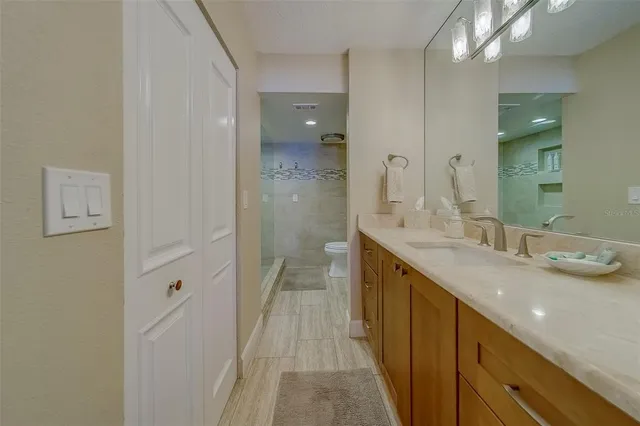 a bathroom with a sink toilet and shower