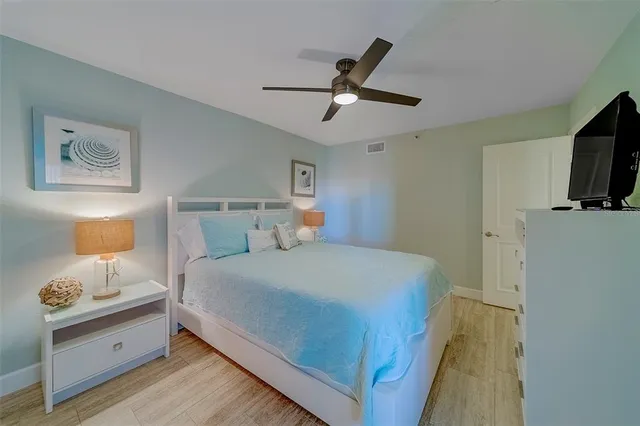 a bedroom with a large bed and a flat screen tv