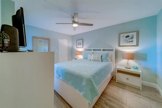 a bathroom with a granite countertop sink a toilet a mirror a vanity and shower