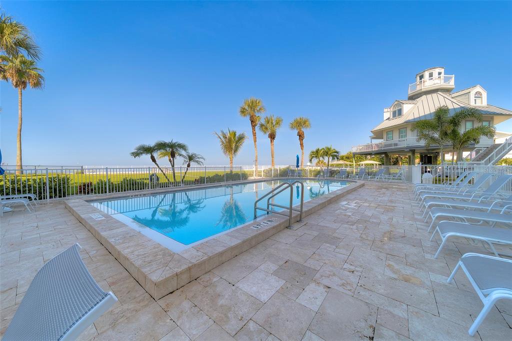 17980 Gulf Boulevard, Unit 402 Redington Shores, FL 33708 - Photo 45 of 63 swimming pool with chairs