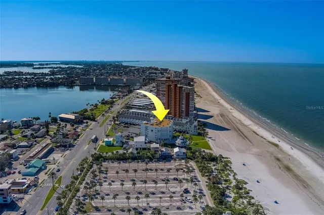 a view of a balcony with chairs and a potted plant